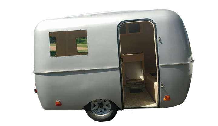 The restored camper has new interior cabinetry and a refinished chrome exterior